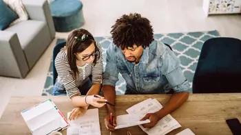 A couple reviewing bills together