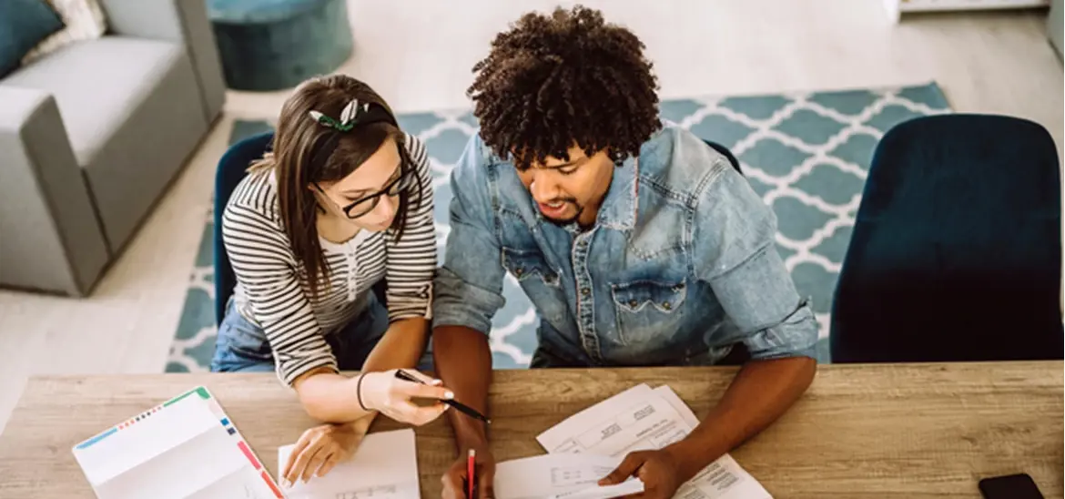 A couple carefully reviewing bills together