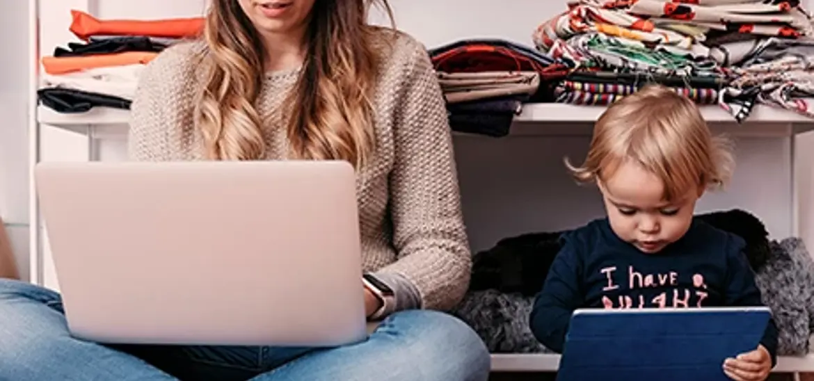 Mom and baby sitting on floor and looking at their own digital screen
