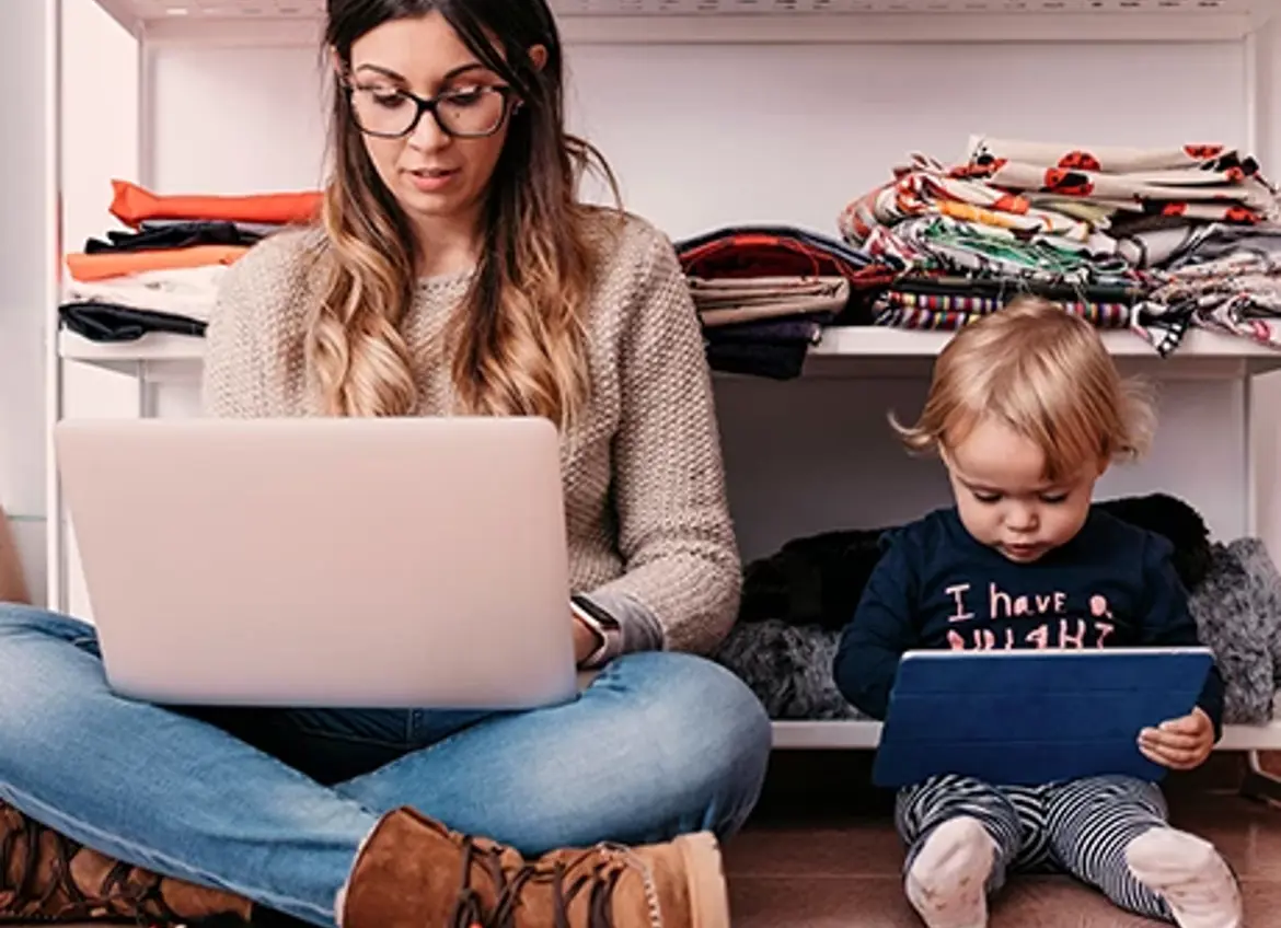 Mom and baby sitting on floor and looking at their own digital screen